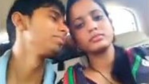 Desi couple shares a passionate kiss in the back seat of a car