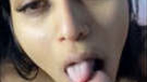 Desi babe sucks on a lollipop while giving a blowjob