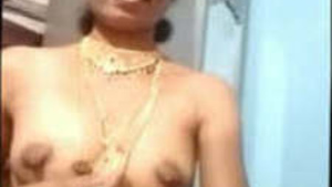 Auntie in traditional jewelry bares her breasts and pussy on camera