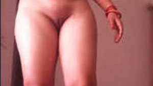 Desi woman stands naked with her legs spread